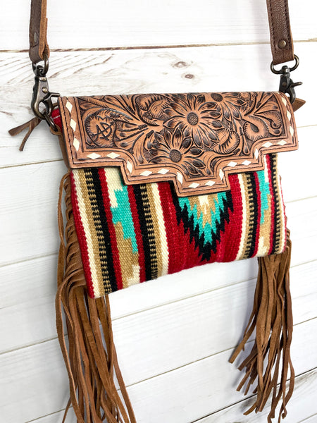 Beautiful western style wool blended with tooled leather flap, leather fringe and crossbody strap